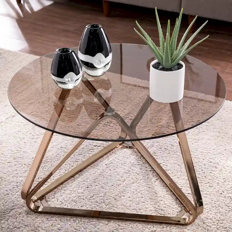 Table basse contemporaine en verre et piètement métallique géométrique couleur champagne